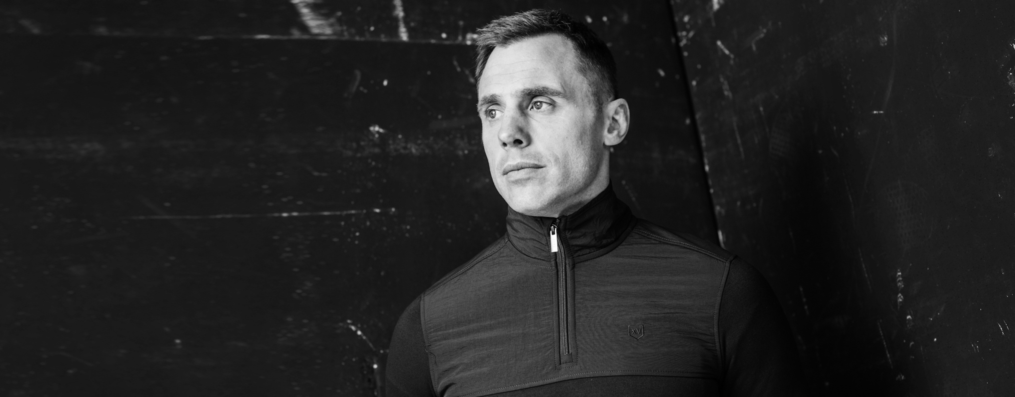 XV Kings by Tommy Bowe menswear featuring a black half-zip top worn by a model in a monochrome setting